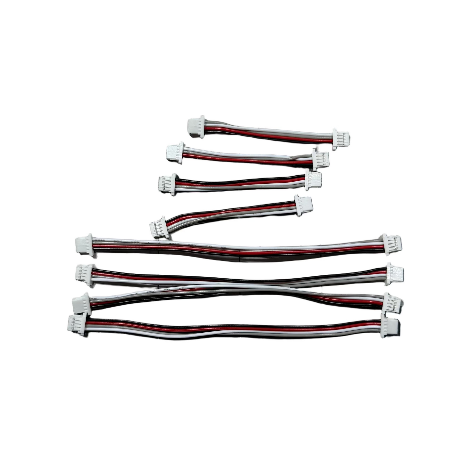 Set of electronic cables on a checkered surface with a keyboard in the background