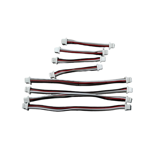 Set of electronic cables on a checkered surface with a keyboard in the background